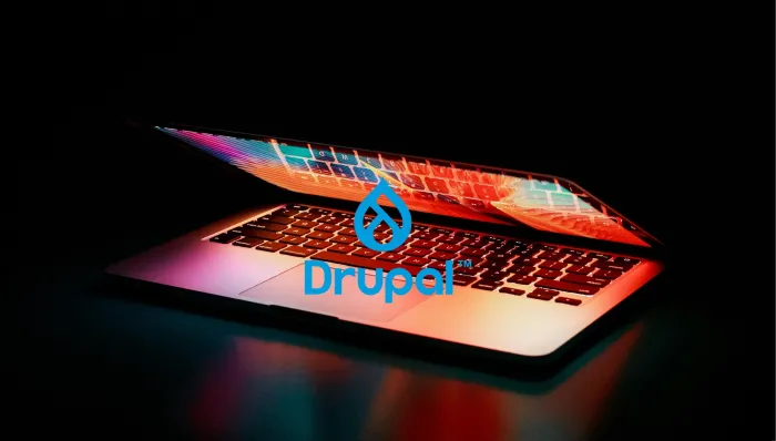 An image of a laptop with the Drupal logo on the center.